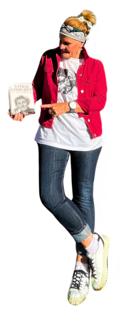 The tour guide stands casually with a book in her hand